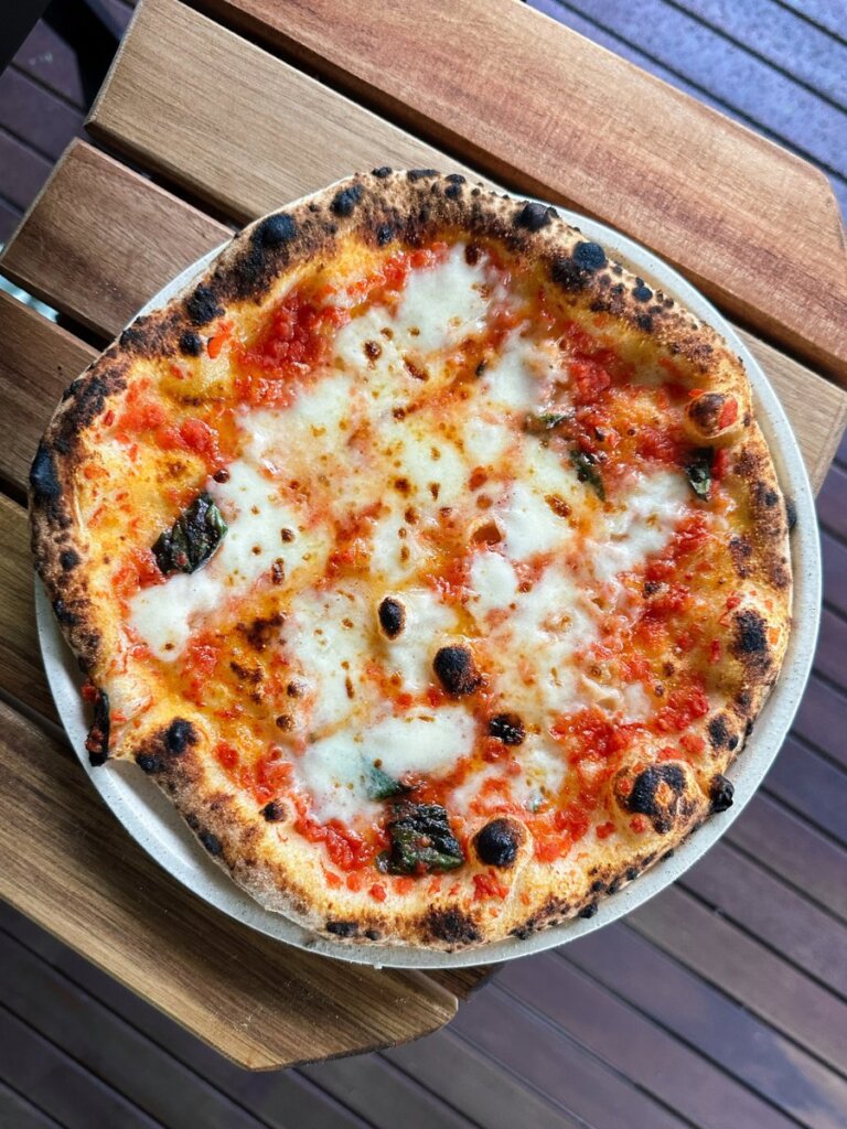 A classic margherita pizza shown top down, with buffalo mozzarella cheese for that classic Neapolitan style finish