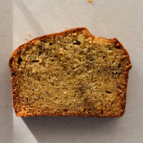 A single slice of brown butter banana bread taken from above so the full crumb is visible.