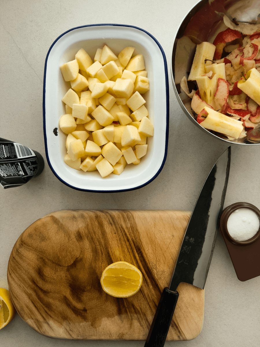 A top-down view of ingredients - apples, vanilla bean paste, lemon and sugar. 