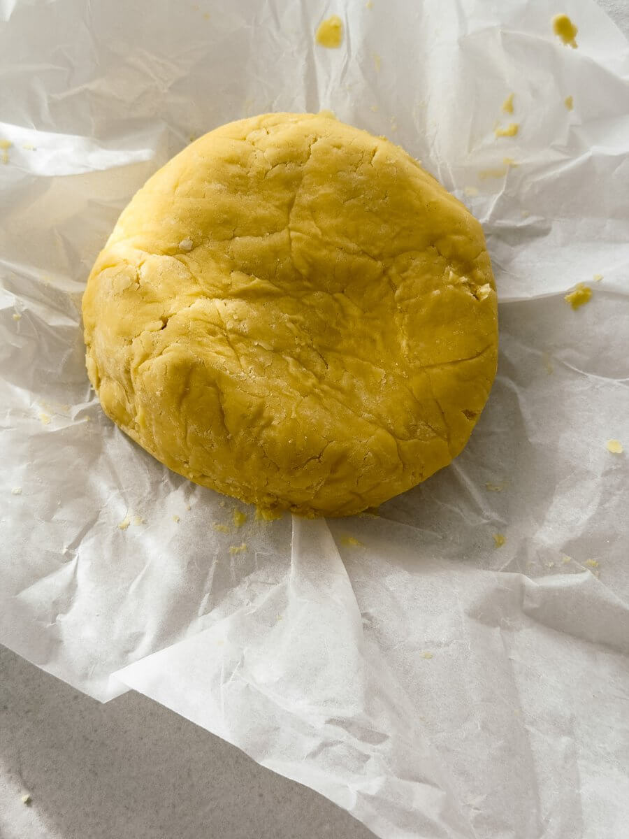 Sweet pastry dough ball in parchment paper.