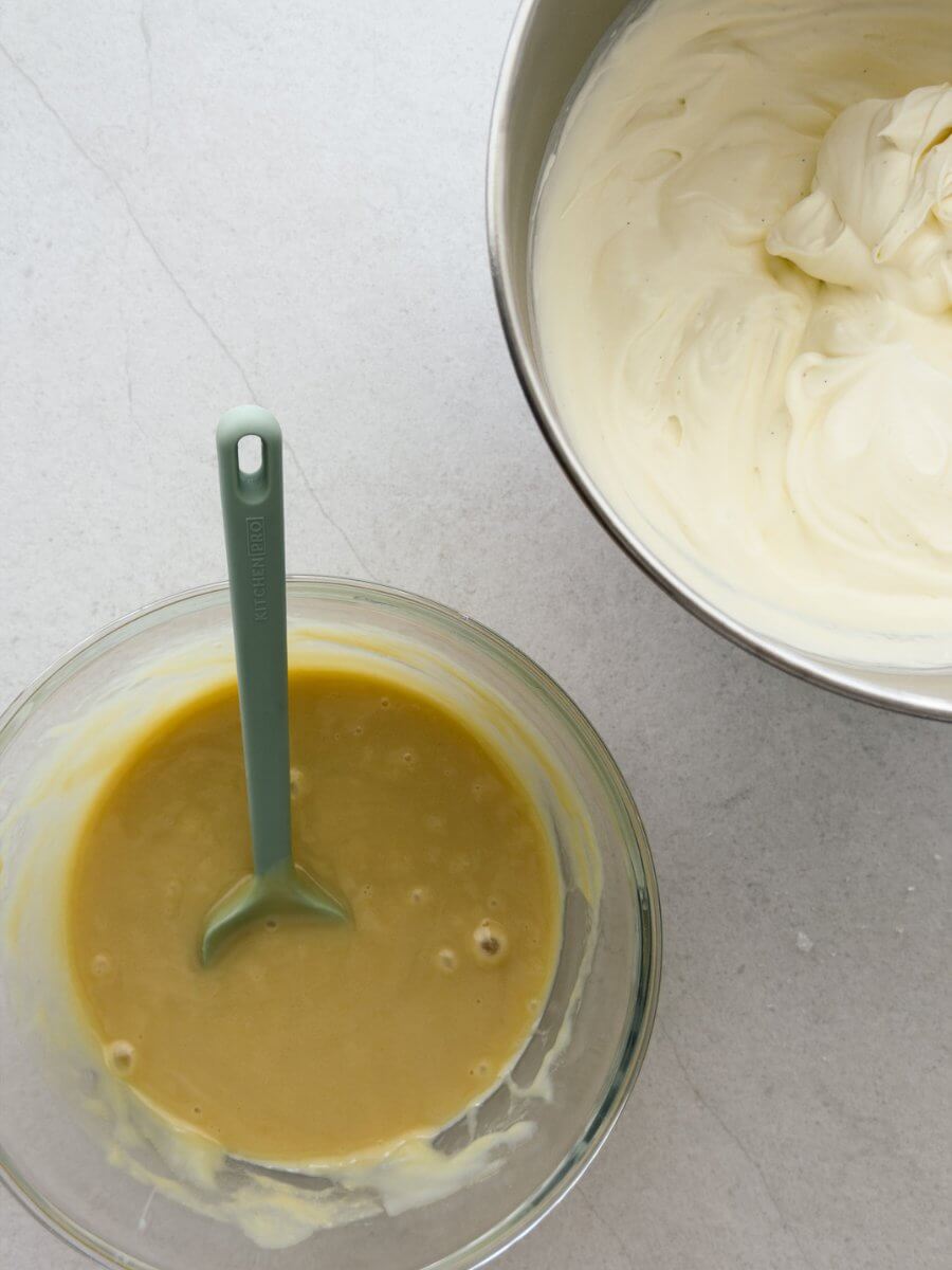 A flat lay style photo of the ingredients in this no churn salted vanilla and tahini ice cream - a tahini and condensed milk cream and a bowl of whipped thickened cream. 