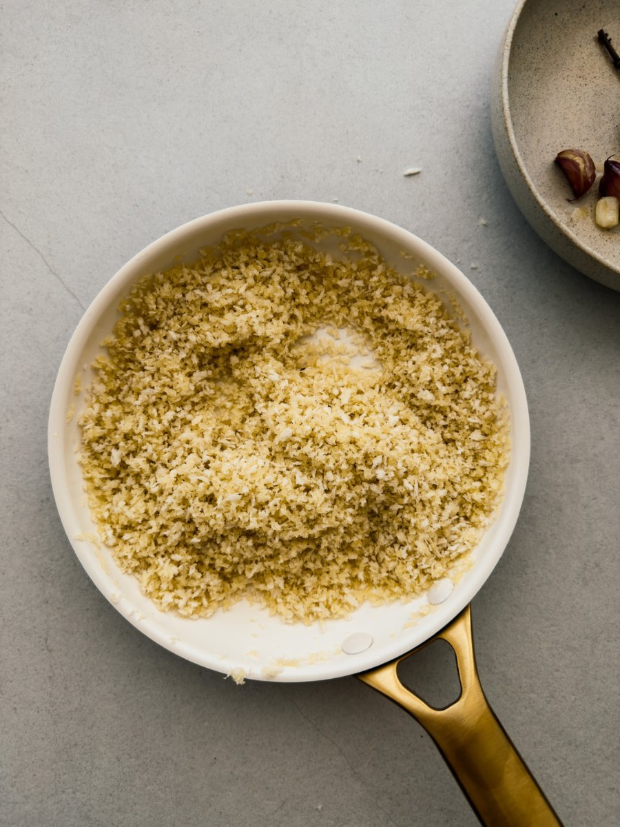 A top down photo of a small saucepan with a panko breadcrumb preparation. 