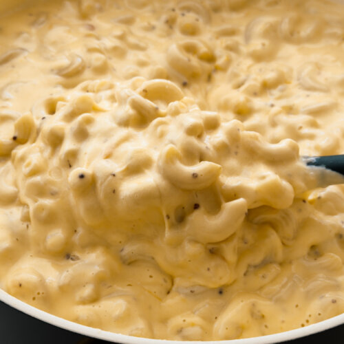 A close up photo of a pot of creamy elbow macaroni and cheese.