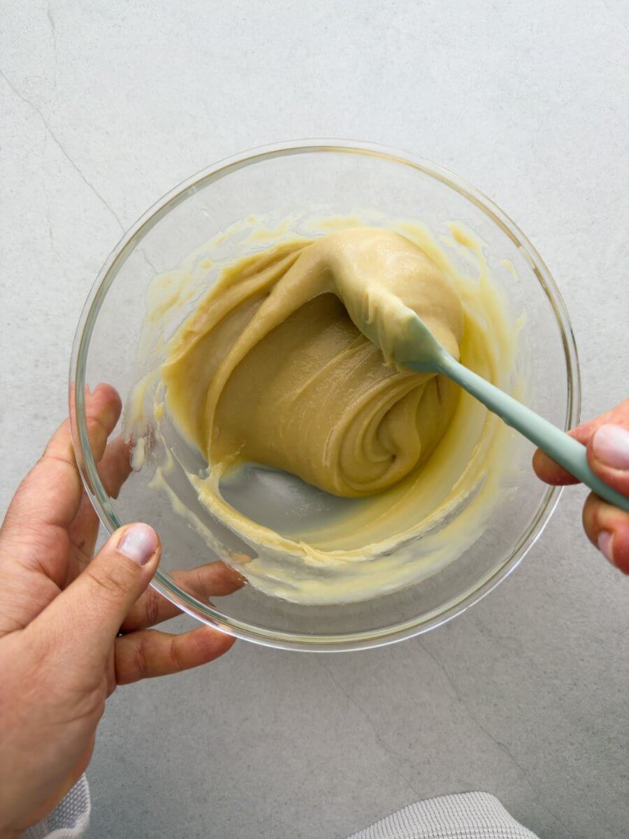 Tahini and condensed milk are mixed together in a bowl. 